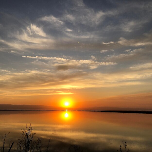 Scenic view of lake against romantic sky at sunset