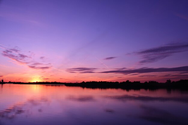 Scenic view of lake against romantic sky at sunset