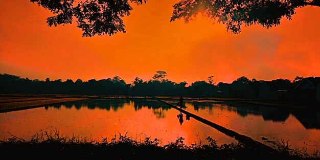 Scenic view of lake against romantic sky at sunset