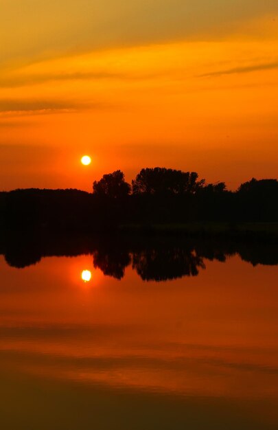 Scenic view of lake against romantic sky at sunset