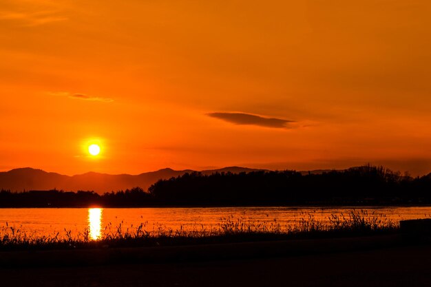 Scenic view of lake against romantic sky at sunset