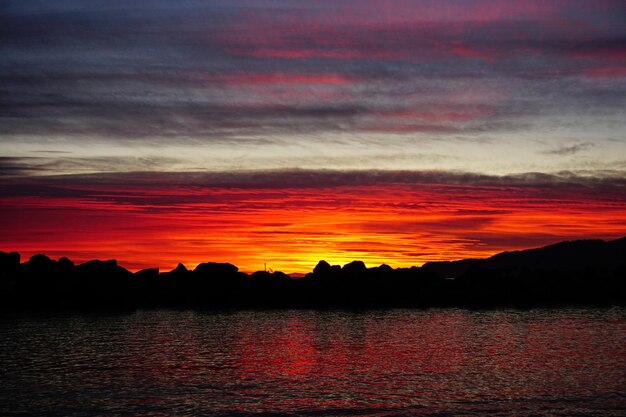 Scenic view of lake against romantic sky at sunset