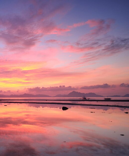 Scenic view of lake against romantic sky at sunset