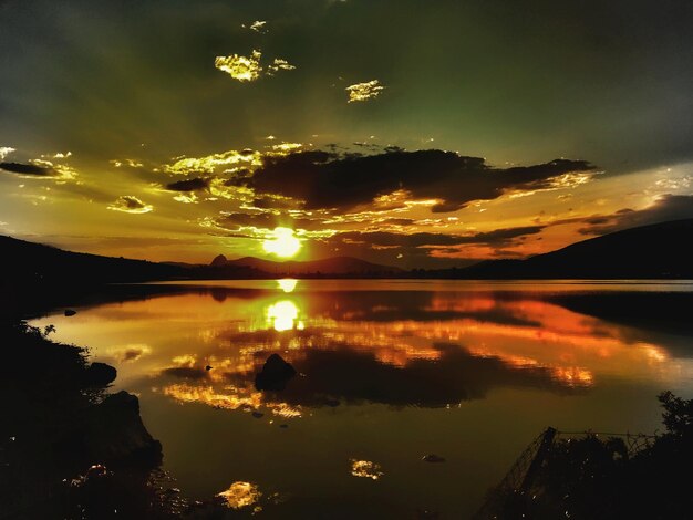 Scenic view of lake against sky during sunset