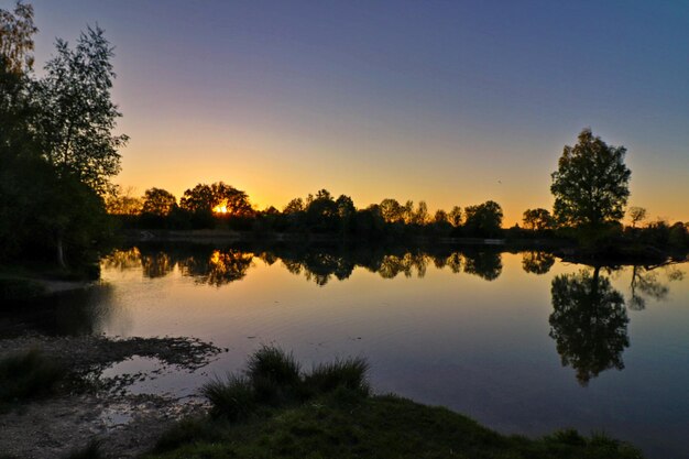 Scenic view of lake against sky during sunset