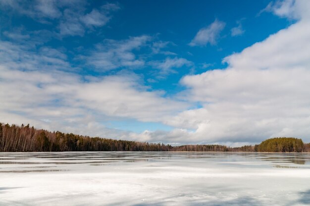 Scenic view of lake against sky during winter