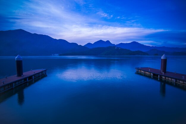 Scenic view of lake against sky at dusk