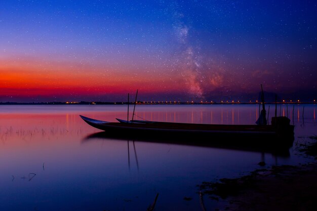 Scenic view of lake against sky at night