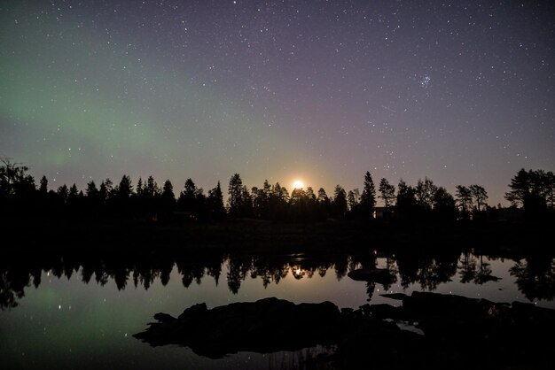 Scenic view of lake against sky at night