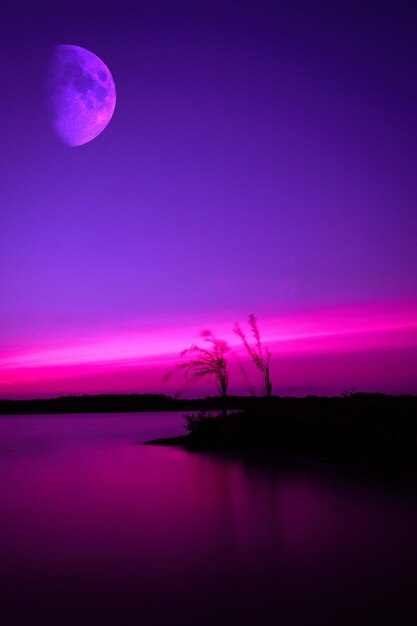 Scenic view of lake against sky at night