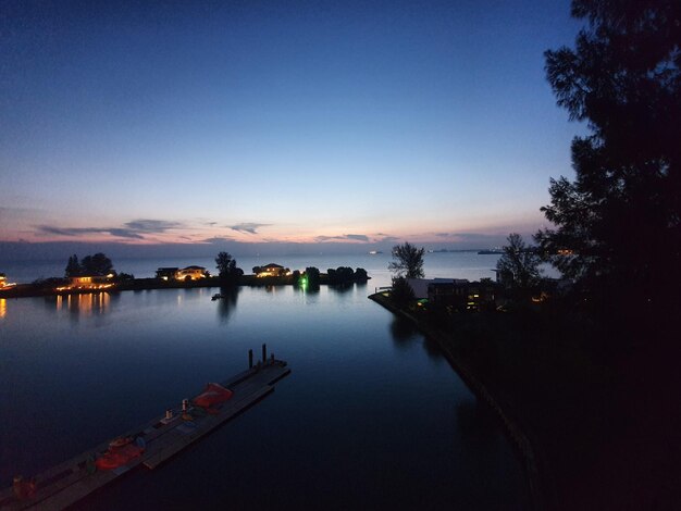 Scenic view of lake against sky at sunset