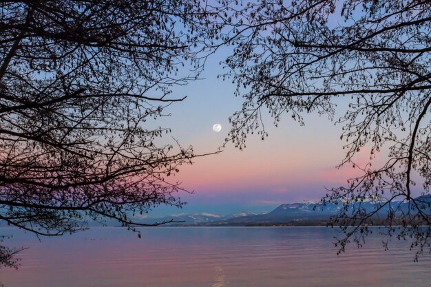 Scenic view of lake against sky at sunset