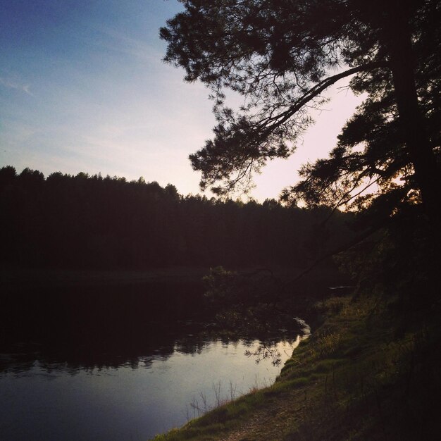 Scenic view of lake against sky at sunset