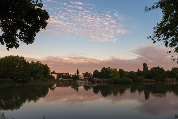 Scenic view of lake against sky at sunset