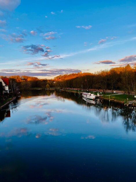 Scenic view of lake against sky at sunset