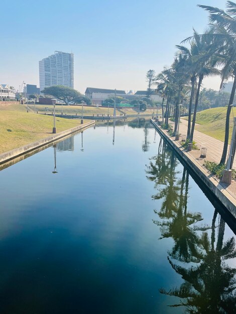 Scenic view of lake by buildings against sky