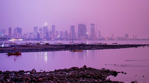 Scenic view of lake by buildings against sky