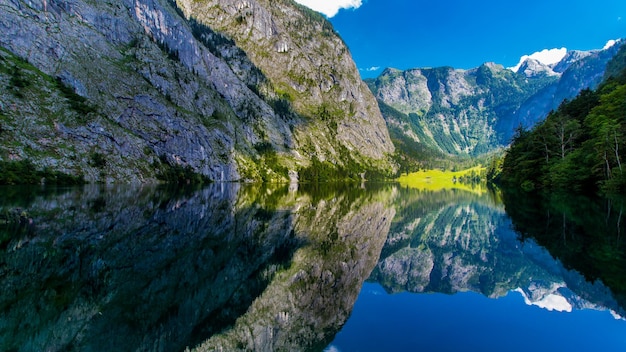 Scenic view of lake by mountain against sky