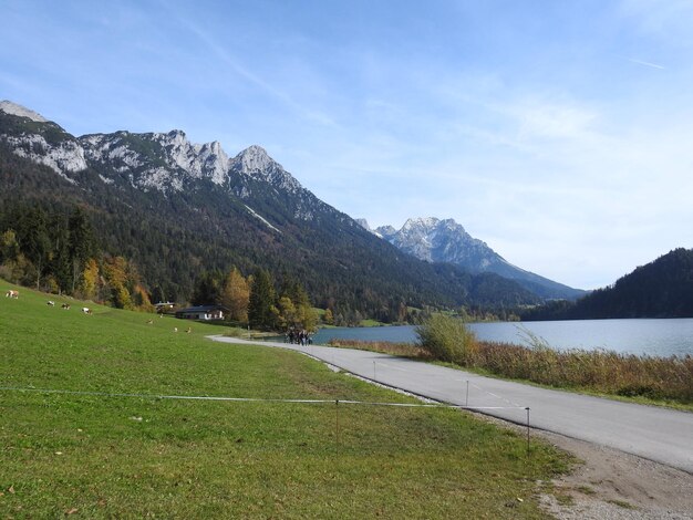 Scenic view of lake by mountains against sky