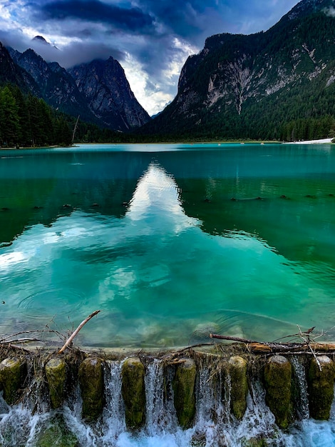 Scenic view of lake by mountains against sky