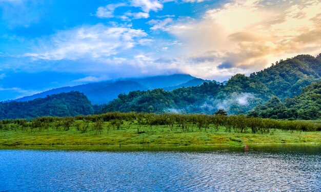 Scenic view of lake by mountains against sky