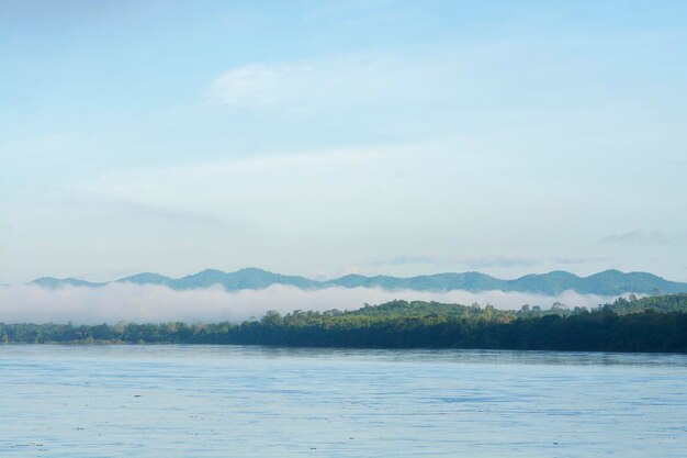 Scenic view of lake by mountains against sky