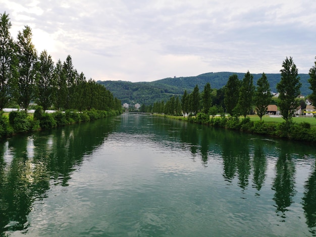 Scenic view of lake by trees against sky