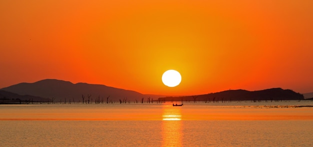 Scenic view of lake kariba and mountains against clear sky during sunset