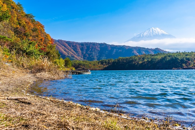 Scenic view of lake and mountains against blue sky