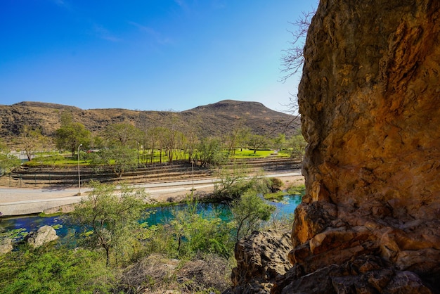 Scenic view of lake and mountains against blue sky