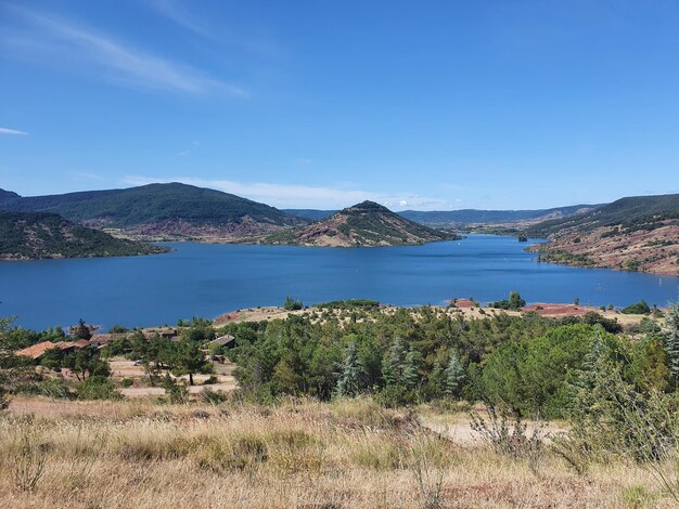 Scenic view of lake and mountains against blue sky