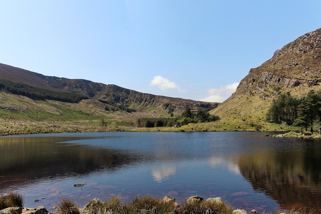 Scenic view of lake and mountains against clear sky