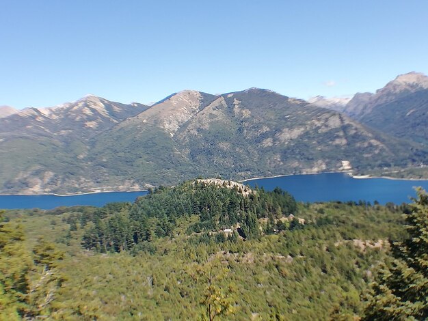 Scenic view of lake and mountains against clear sky