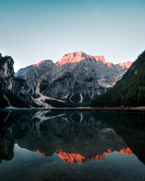 Scenic view of lake and mountains against sky during sunrise