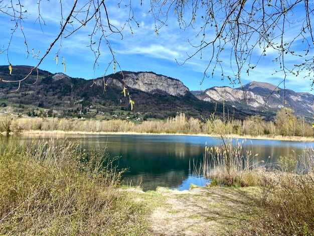 Scenic view of lake and mountains against sky