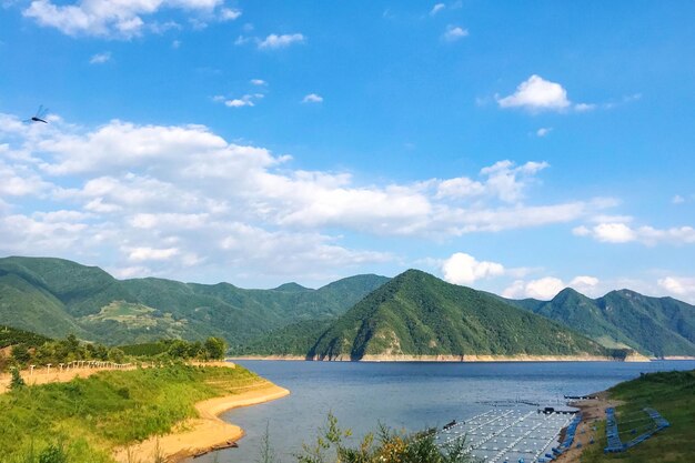 Scenic view of lake and mountains against sky