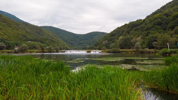 Scenic view of lake and mountains against sky