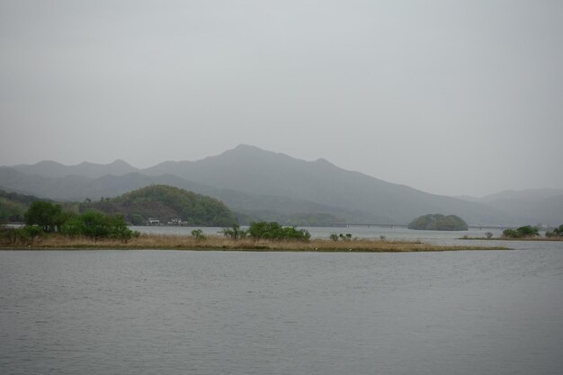 Scenic view of lake and mountains against sky