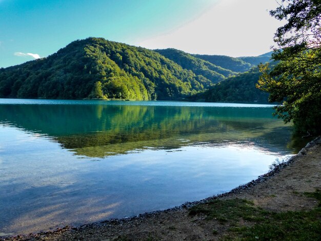 Photo scenic view of lake and mountains against sky