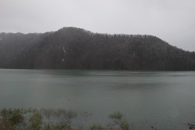 Scenic view of lake and mountains against sky