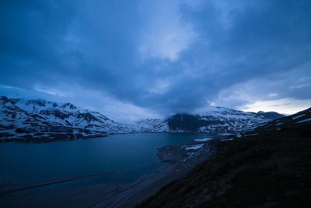 Scenic view of lake and snowcapped mountains against sky