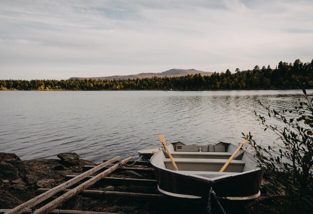 Scenic view of lake with boat against sky