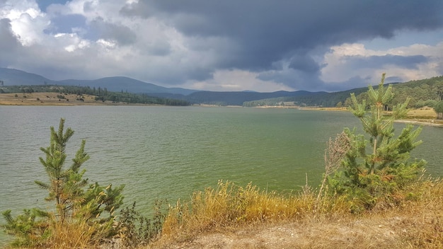 Scenic view of lake with mountains in background