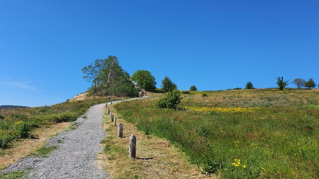 Scenic view of land against clear blue sky