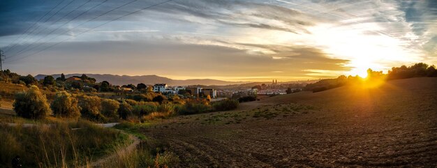 Scenic view of land against sky during sunset