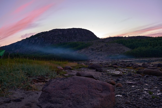 Scenic view of land against sky at sunset