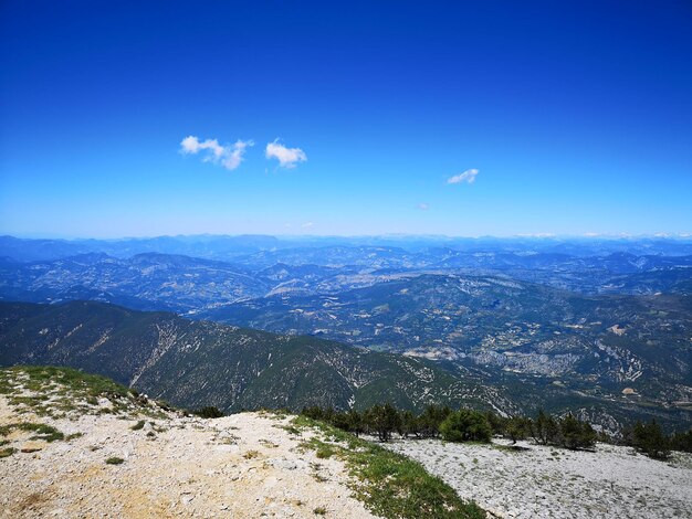 Scenic view of landscape against blue sky