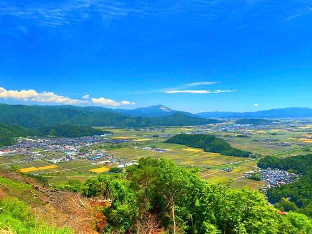 Scenic view of landscape against blue sky