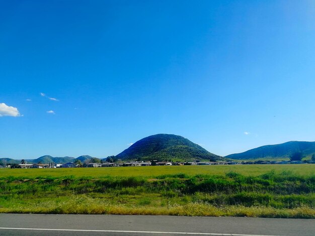 Scenic view of landscape against blue sky