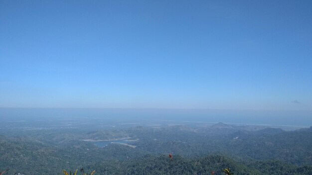 Scenic view of landscape against clear blue sky